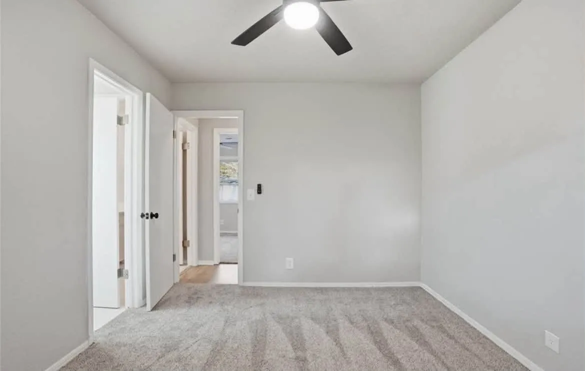 Crisp white painted doors, door frames, and baseboards in a bedroom
