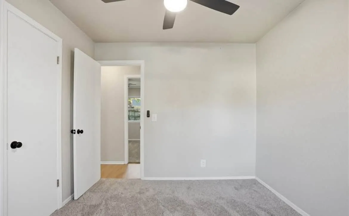 Bedroom with fresh gray walls and crisp white trim and doors