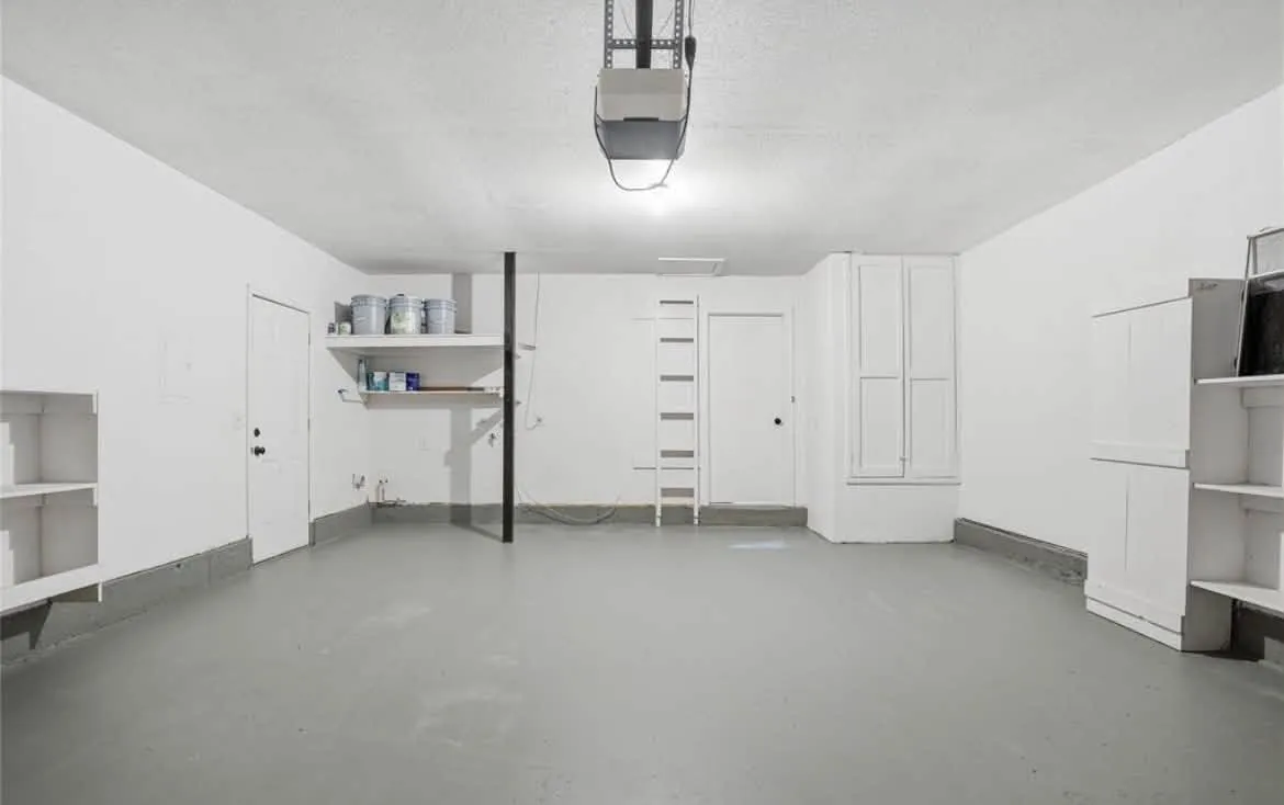 Garage with freshly painted white walls and gray painted floor