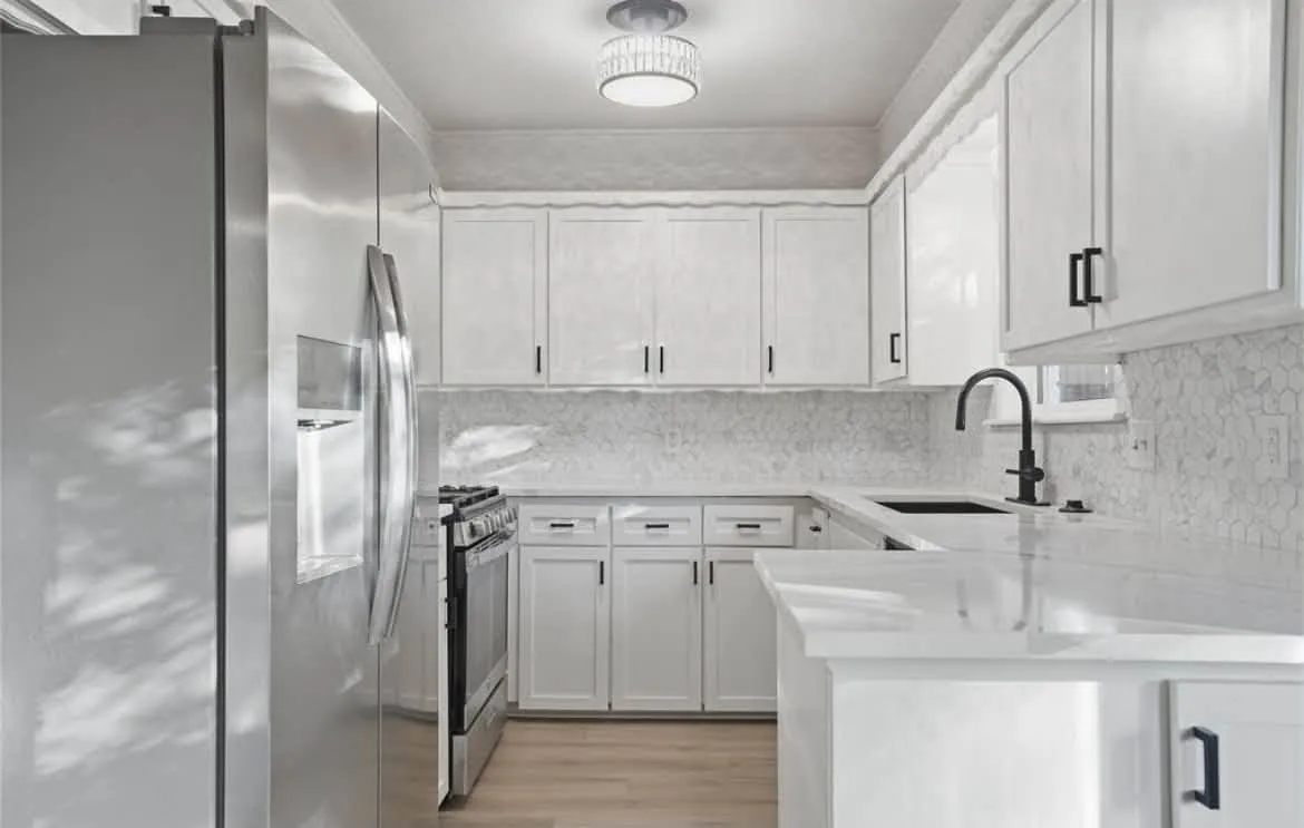 Bright kitchen with white painted walls and cabinets